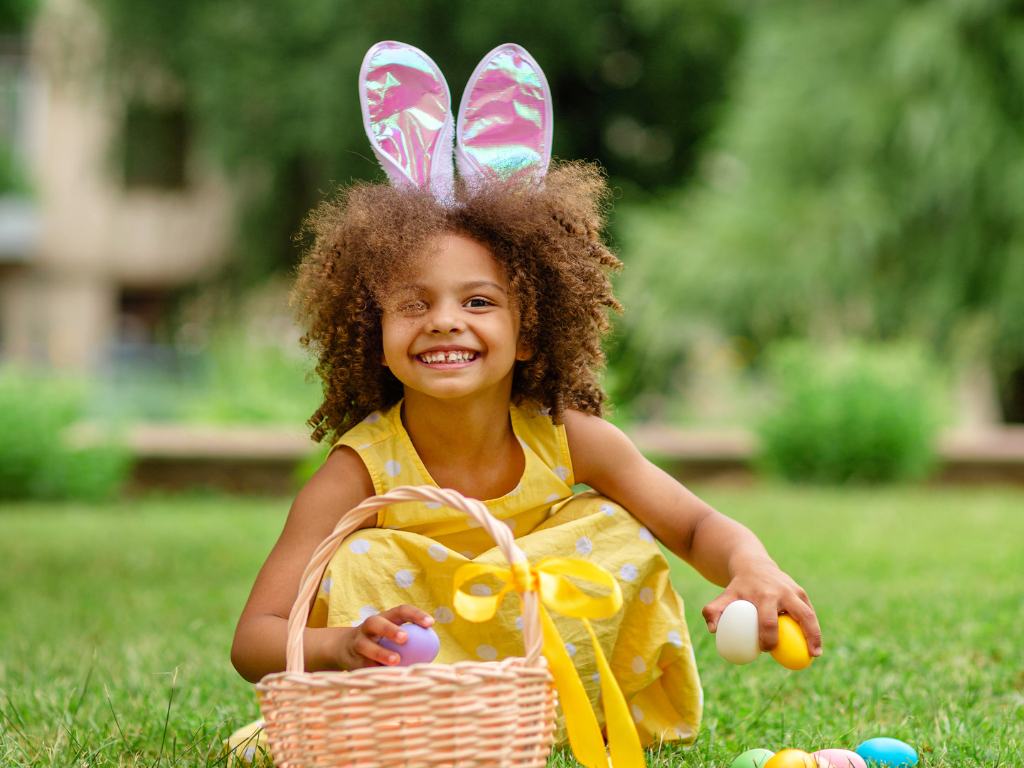 Little girl with easter basket wearing bunny ears