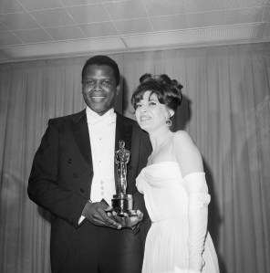 Sidney Poitier receives an Oscar presented by Anne Bancroft in Santa Monica, California, on April 13, 1964. He won Best Performance by an Actor for his role in the 1963 film Lilies of the Field.
