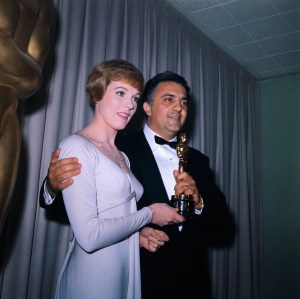 (Original Caption) Academy Award Presentations. Hollywood, California: Actress Julie Andrews presents award for "Best Foreign Language Film of the Year" to Italian director Federico Fellini for his film 8 1/2.