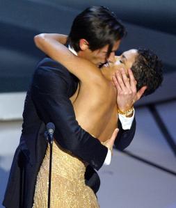 Actor Adrien Brody kisses presenter Actress Halle Berry as he accepts his Oscar for Performance by an actor in a leading role for his role in "The Pianist" during the 75th Academy Awards at the Kodak Theatre in Hollywood, California, 23 March, 2003.   (Photo credit should read TIMOTHY A. CLARY/AFP via Getty Images)