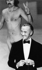 'Streaker' Robert Opel flashes a victory sign behind co-host David Niven at the 46th Annual Academy Awards, Dorothy Chandler Pavilion, Los Angeles, April 2, 1974